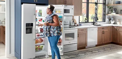 maytag-white-refrigerator-woman-grabbing-items